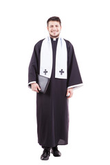 Young priest holding a holy bible isolated on white background