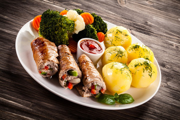 Wrapped pork chop, boiled potatoes and vegetables