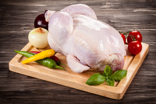 Raw chicken on cutting board