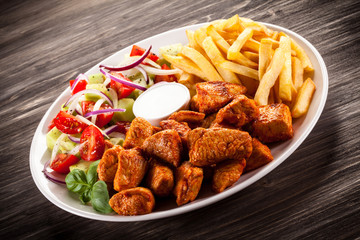 Fried chicken nuggets, French fries and vegetables
