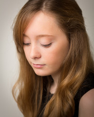 Naklejka premium Ginger Teenage Girl Looking Down