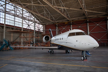 Fototapeta premium Business jet airplane stays in hangar..
