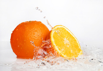 fresh orange in water spray