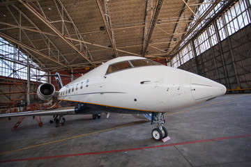 Business jet airplane stays in hangar.