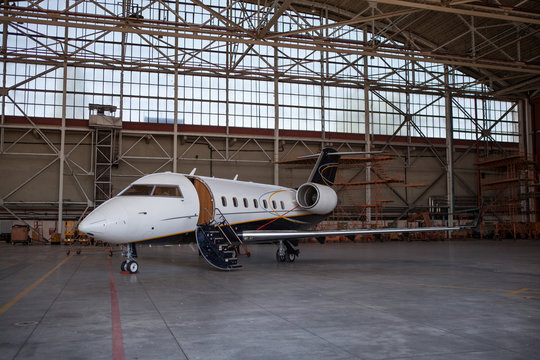 Business jet airplane stays in hangar.