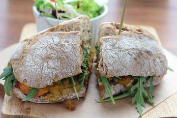 Bombay masala sandwich with chicken, rocket and green salad.
