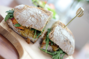 Bombay masala sandwich with chicken, rocket and green salad.