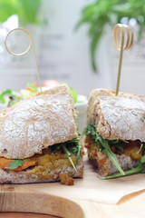 Bombay masala sandwich with chicken, rocket and green salad.