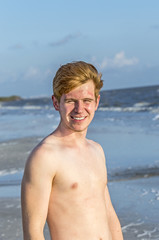 handsome confident teenager in sunset at the beach