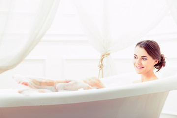 Obraz na płótnie Canvas Beautiful young woman taking a bath