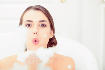 Beautiful young woman taking a bath