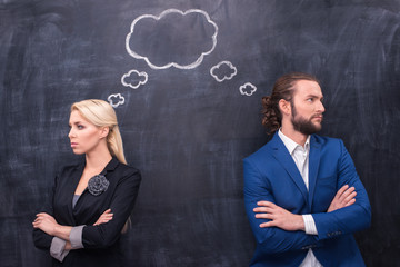 Male and female thinking together on th blackboard background