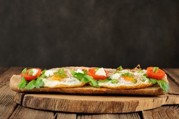 Rye bread egg sandwich with tomatoes and greens