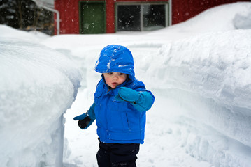 Boy Looking at Snow on His Glove in the Winter - 78155564