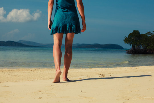 Young woman walking on tropical beach