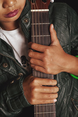 Female hands holding an acoustic guitar