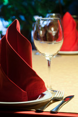 Table in a restaurant with tablecloth, napkins, wine glasses