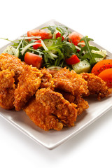 Fried chicken nuggets and vegetables