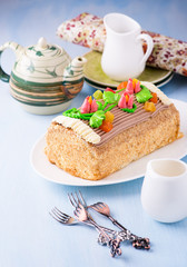 Roulade cake, decorated with colourful buttercream flowers
