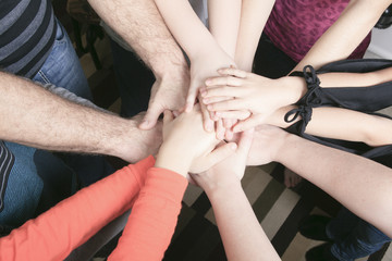 Many hands together inside family house