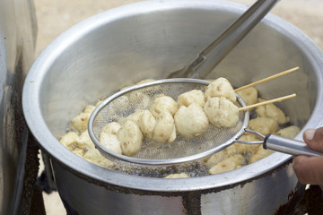 Meatballs frying in a pot