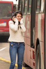 woman walking on the city street covering her ears concept of