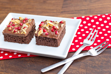 chocolate cake decorated with pomegranate and almond