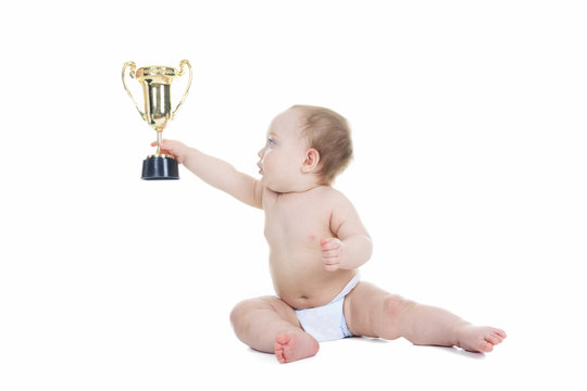 A baby holding gold trophy cup on a white background