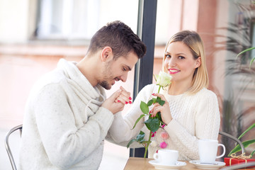 Romantic young couple sitting in a cafe on Valentine's Day