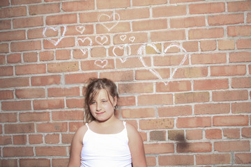 A child with brink wall as a background