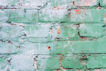 Textured old green wall of brick with traces of rubbing