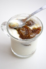 Cup of yogurt with spoon and figs