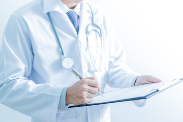 Close-up of male hands filling in medical form