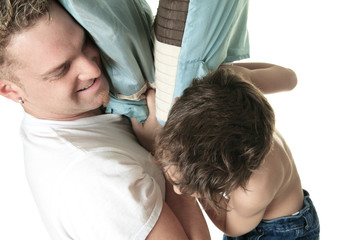 Boy hitting her father with pillow