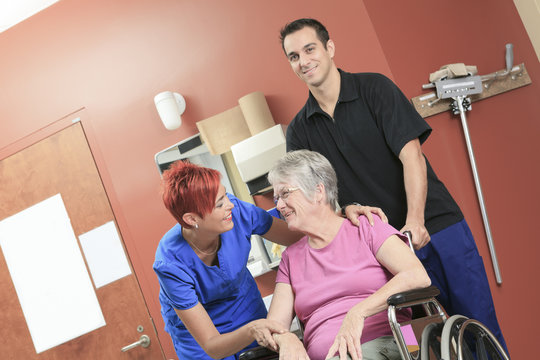 Elderly lady with her physiotherapists in a hospital