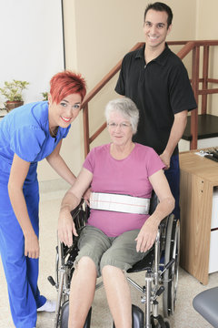 Elderly lady with her physiotherapists in a hospital