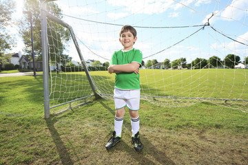 Kid play soccer on a field