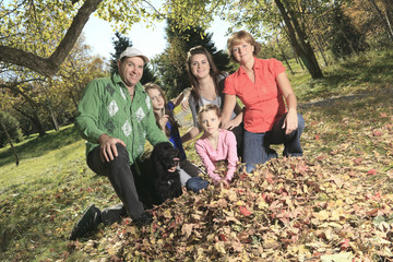 family throw autumnal leaves