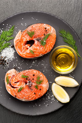 Fresh fish salmon with salt, dill and lemon. Top view.
