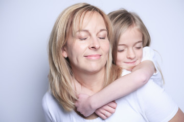 A mother with is daughter over gray background