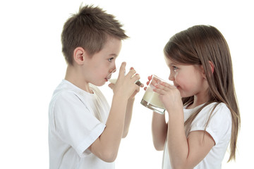 Obraz na płótnie Canvas Little boy drinking milk on white background. Studio shot
