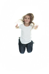 Happy little girl is jumping against white isolated background