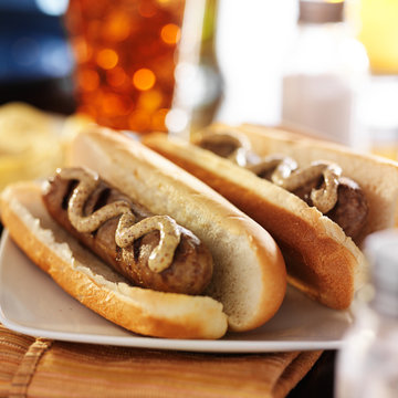 bratwursts in hot dog buns with gourmet mustard