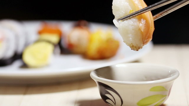 Sushi keep chopsticks and dipped into the sauce,Japanese Food.
