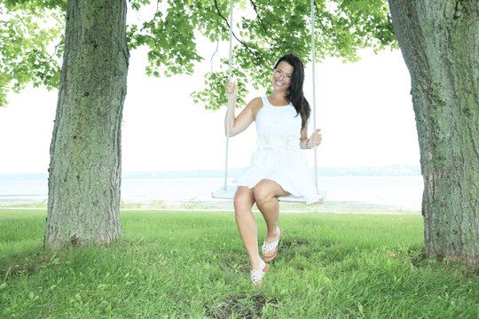 A Adult Woman Sit On A Swing