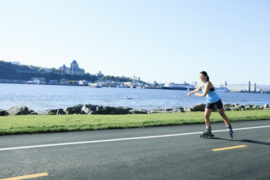 A woman with is rollerblade in summer time