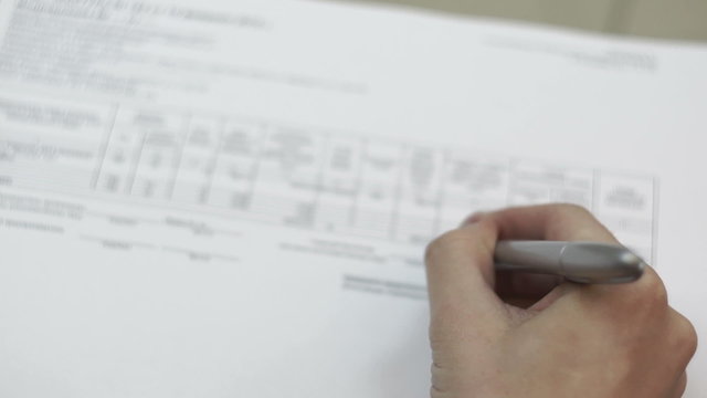 man puts a stamp and signature on the document