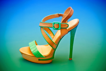 women's high-heeled shoes on the blue - green background