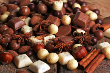 Different kinds of chocolates on wooden table close-up