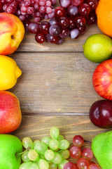 Assortment of juicy fruits on wooden background